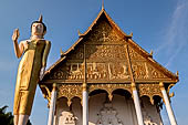 Vientiane, Laos - Pha That Luang, the elegant structure, Wat That Luang Neua, with a very ornate front faade fronted by two tall standing Buddha statues. 